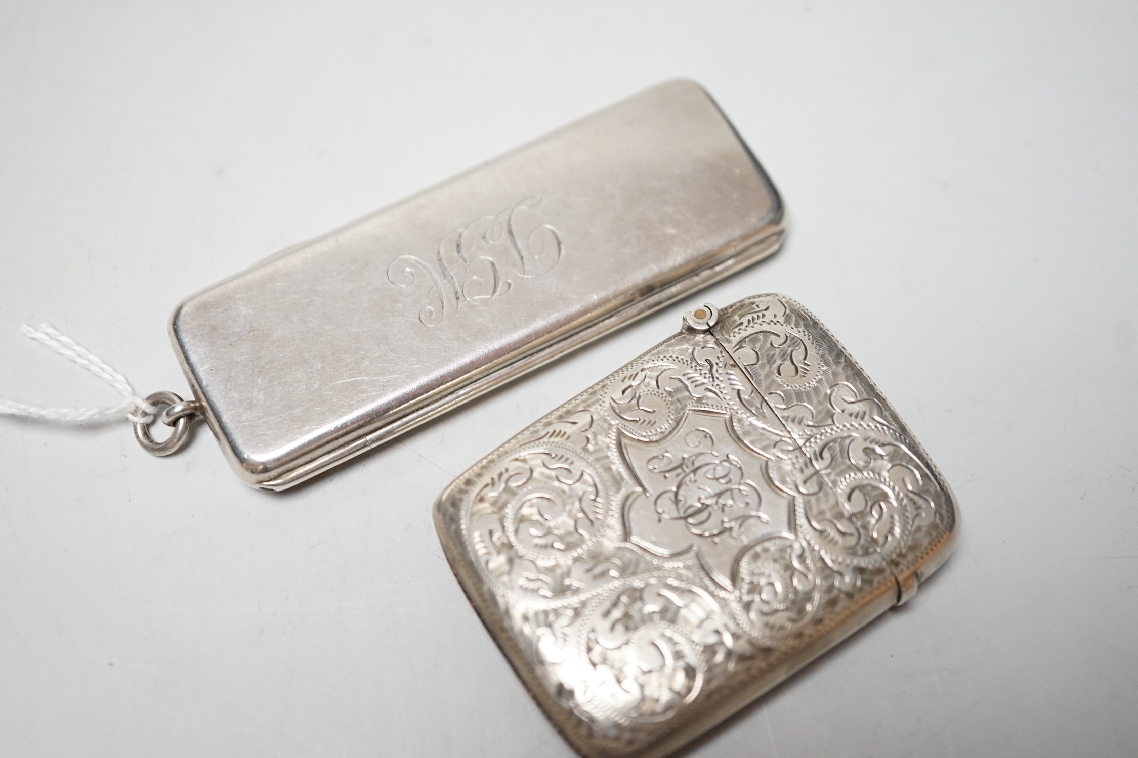 An Edwardian silver rectangular cigarette paper dispenser, maker WH, no assay office mark, circa 1908, 77mm and a silver vesta case.